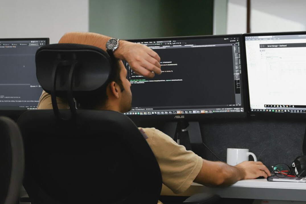 person coding at desk