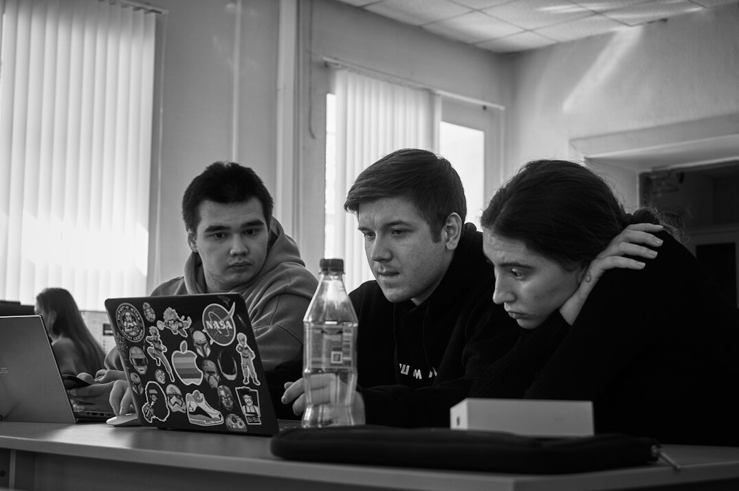 students coding together